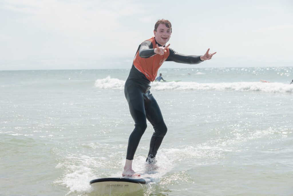 a man is smiling while surfing