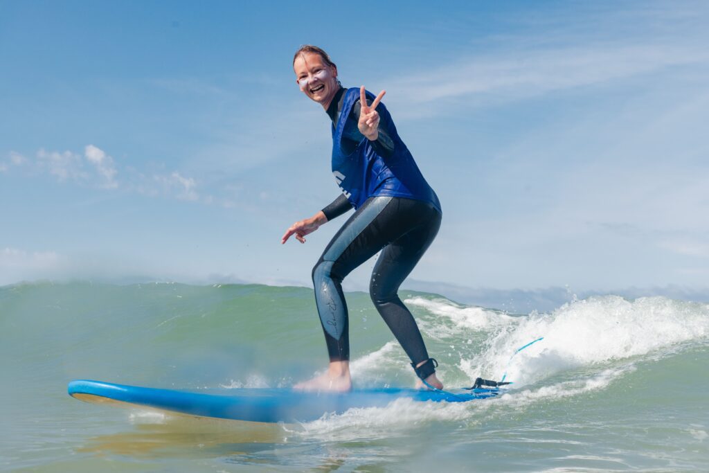 a woman is smiling while surfing