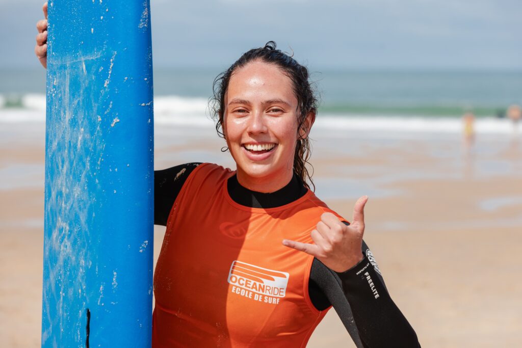 a woman is smiling while surfing at ocean ride