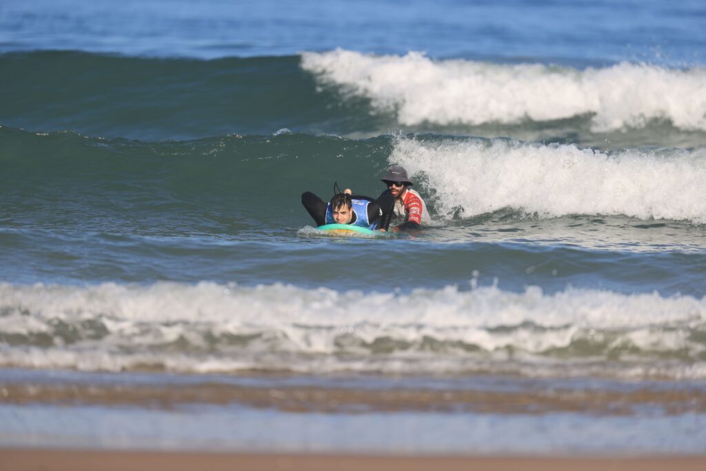 a surf coach and his student in the ocean